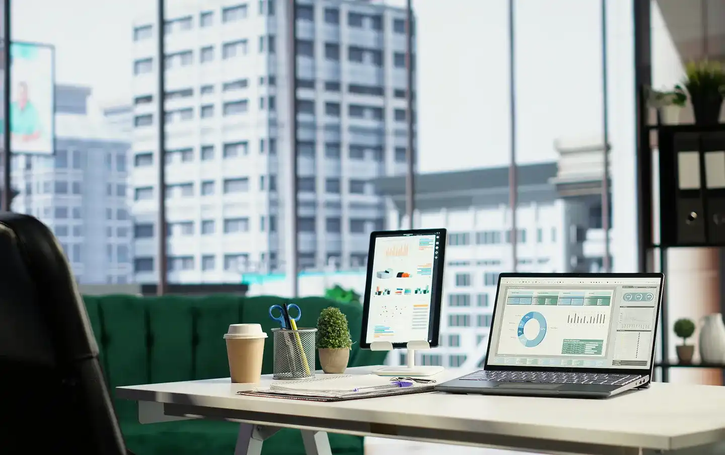 Real estate analytics dashboard with performance charts in a modern downtown office, illustrating real estate software development services built for CRM and property management needs.
