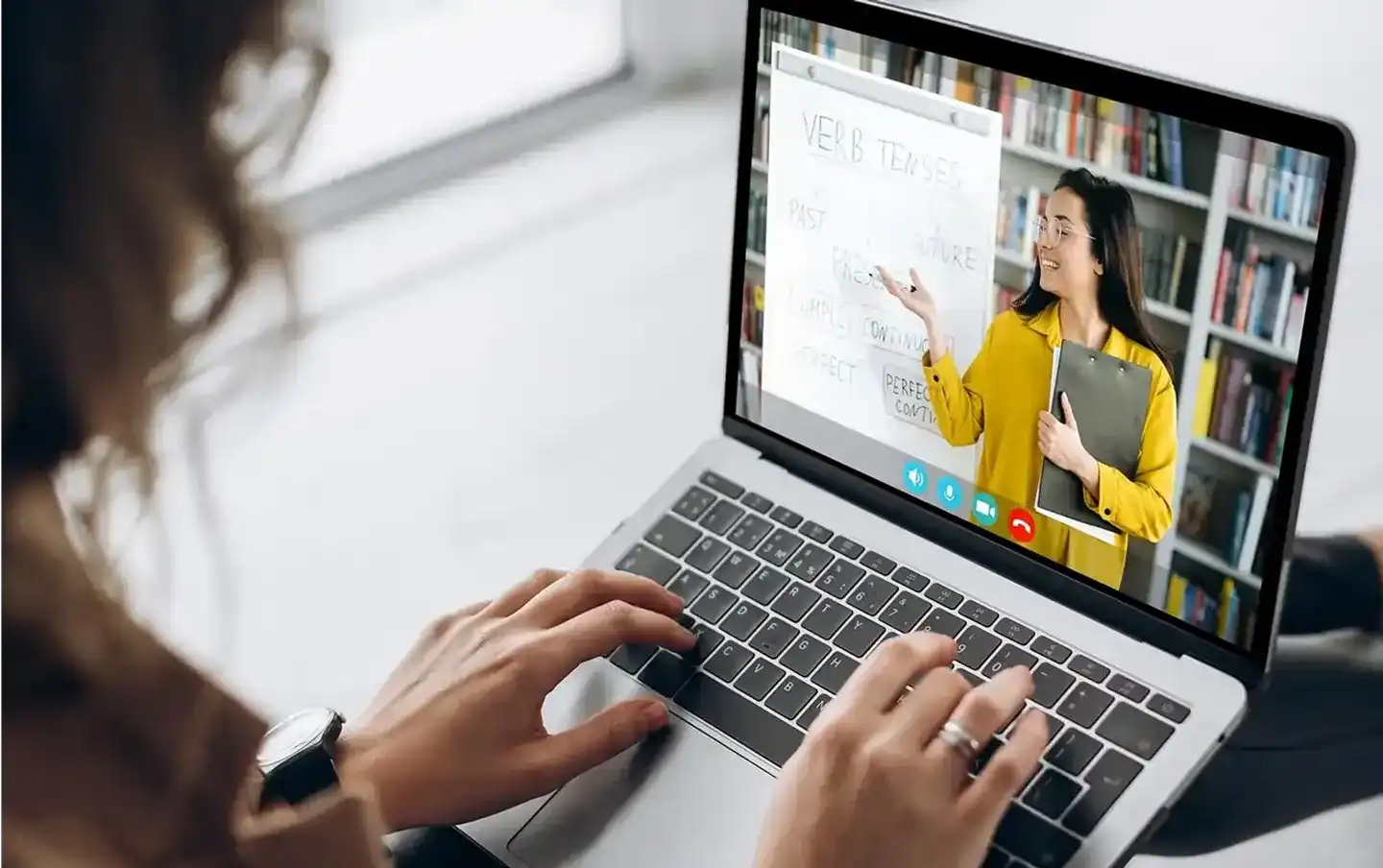 Student attending an online class with a teacher on a laptop, illustrating custom education software development services for remote learning platforms.