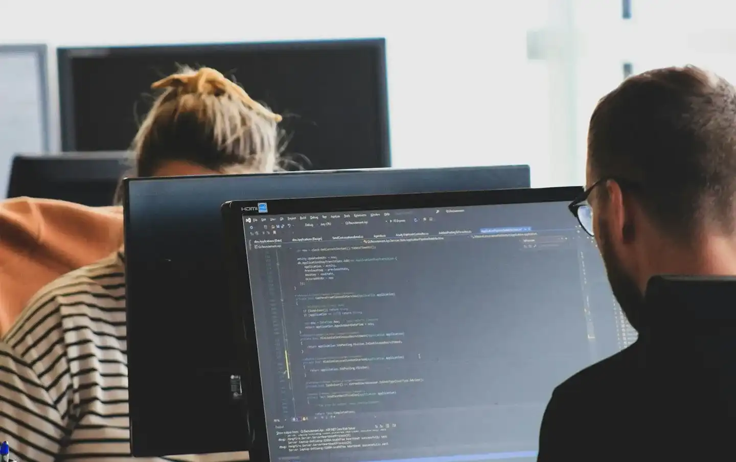 Development team collaborating on codebase fixes and technical support, illustrating software maintenance services built for reliable, long-term system upkeep.
